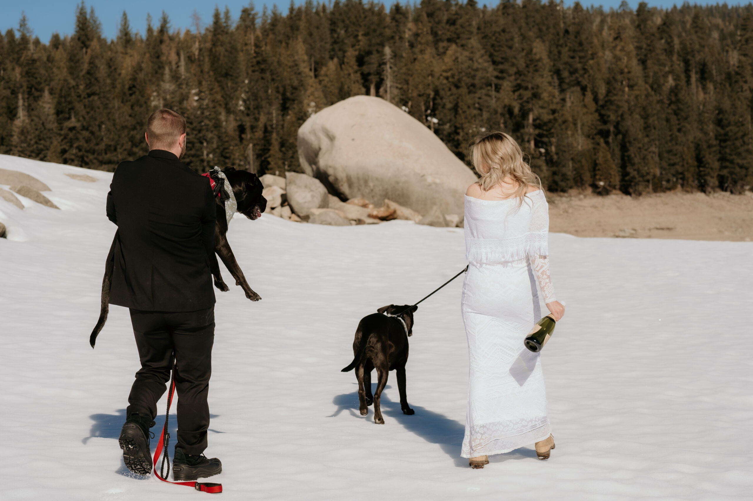 Couple walking through snow at Bear River Reservoir elopement