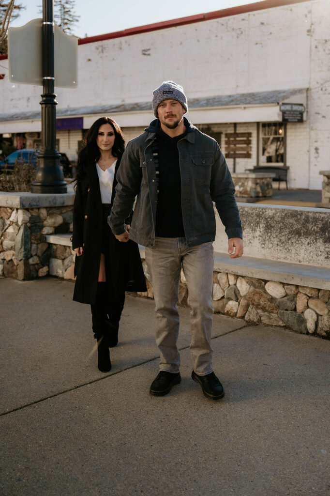 Couple holding hands walking through downtown sutter creek for their couples photoshoot