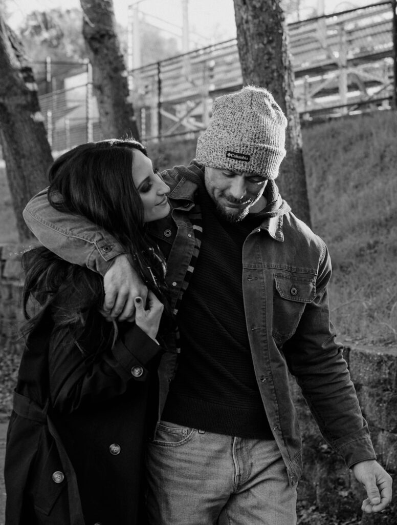 A couple hugging as they walk along downtown sutter creek during their couples session