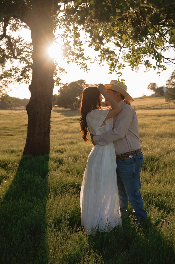 A golden hour photo showcases an engaged couple during a farm engagement photoshoot with california engagement photographer