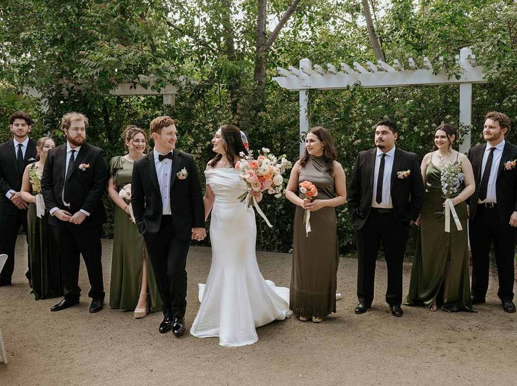 Newlyweds and their wedding party are photographed in a bridal portrait taken at a california garden wedding
