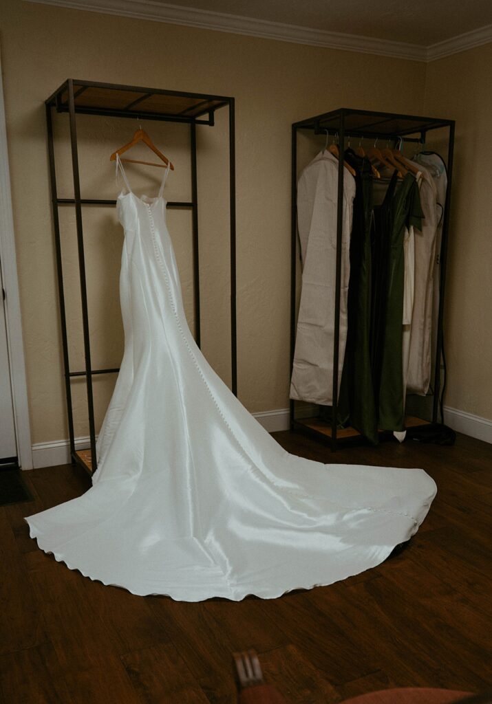A wedding gown is photographed before a california garden wedding