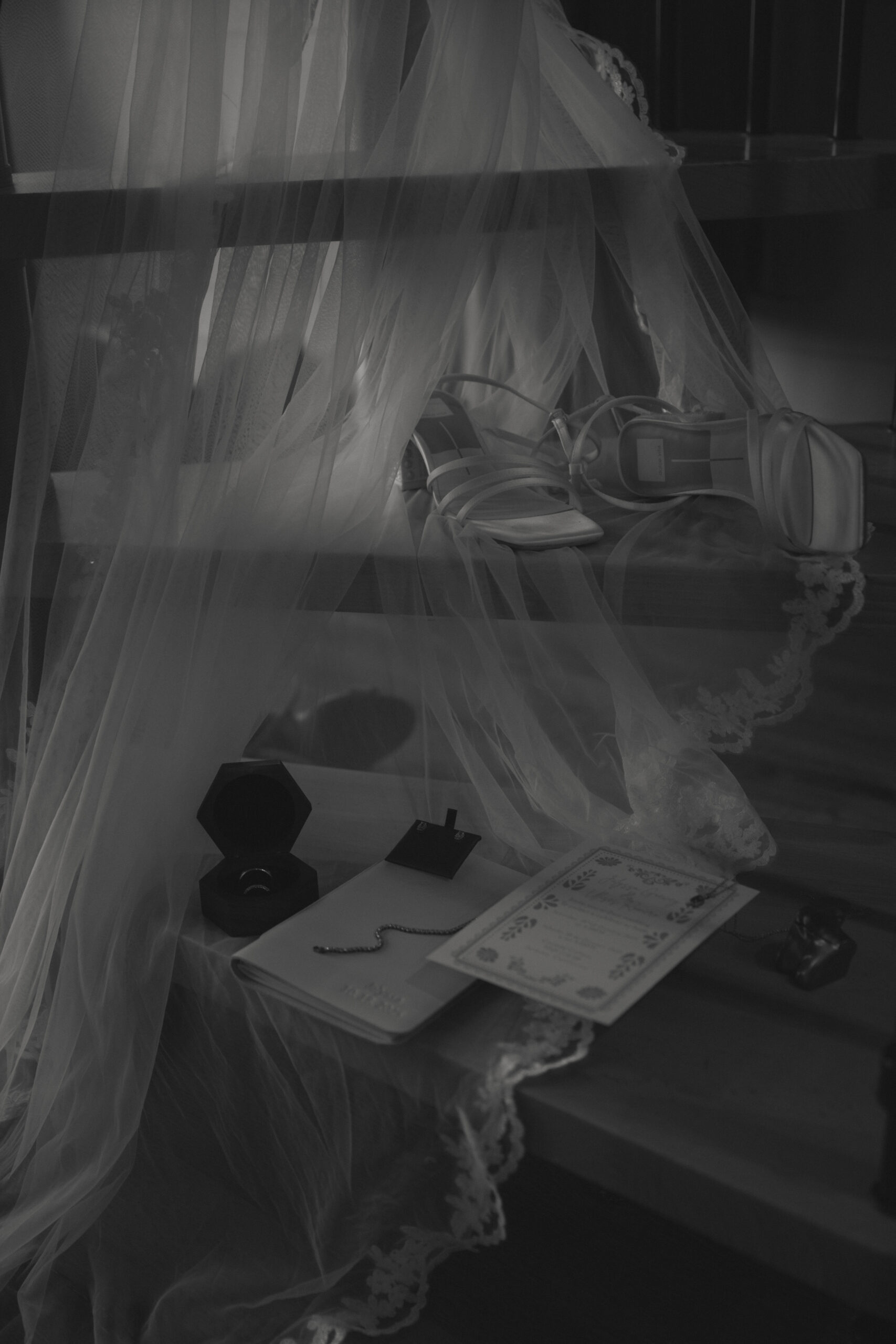 black and white image of Wedding details beautifully draped along stairs