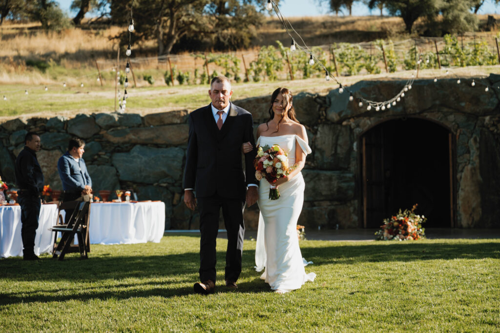 The bride come down the aisle with her father by her side