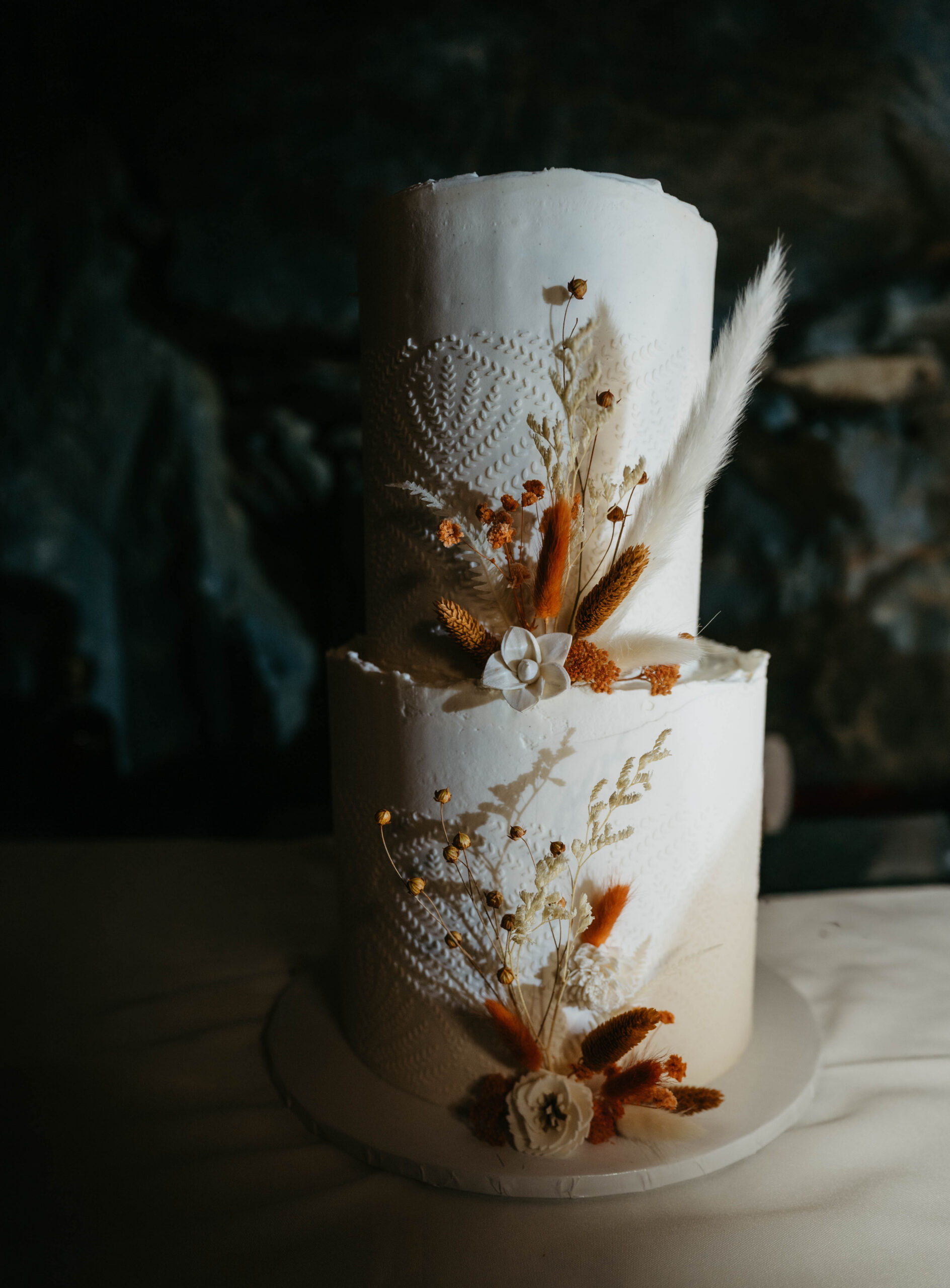 Beautiful Bohemian wedding cake with burnt orange details