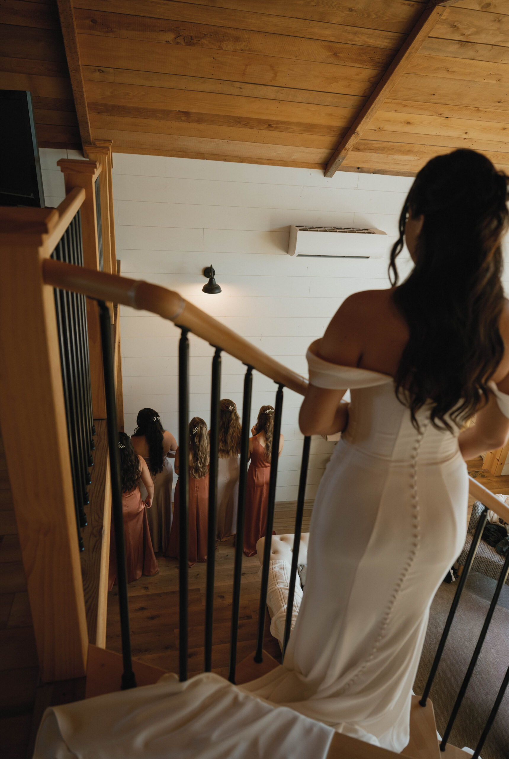 Bride looks over her bridesmaids during first look with her bridal party.