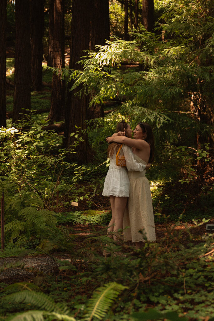 Couple embracing in the redwoods after their proposal, photographed in Oregon